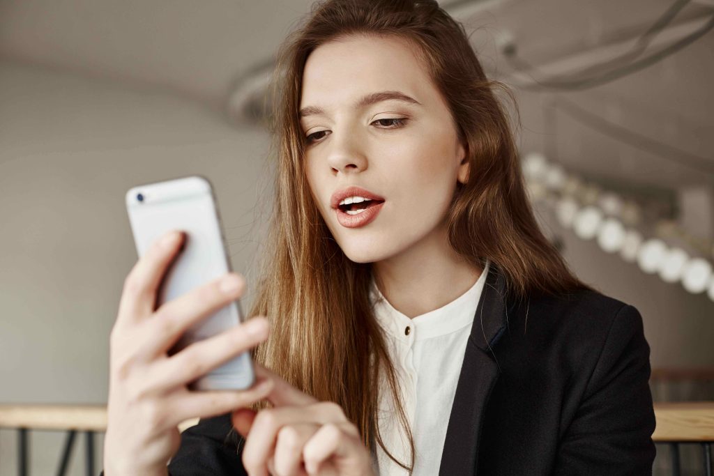 gorgeous-young-woman-using-mobile-phone-co-working-space-11zon